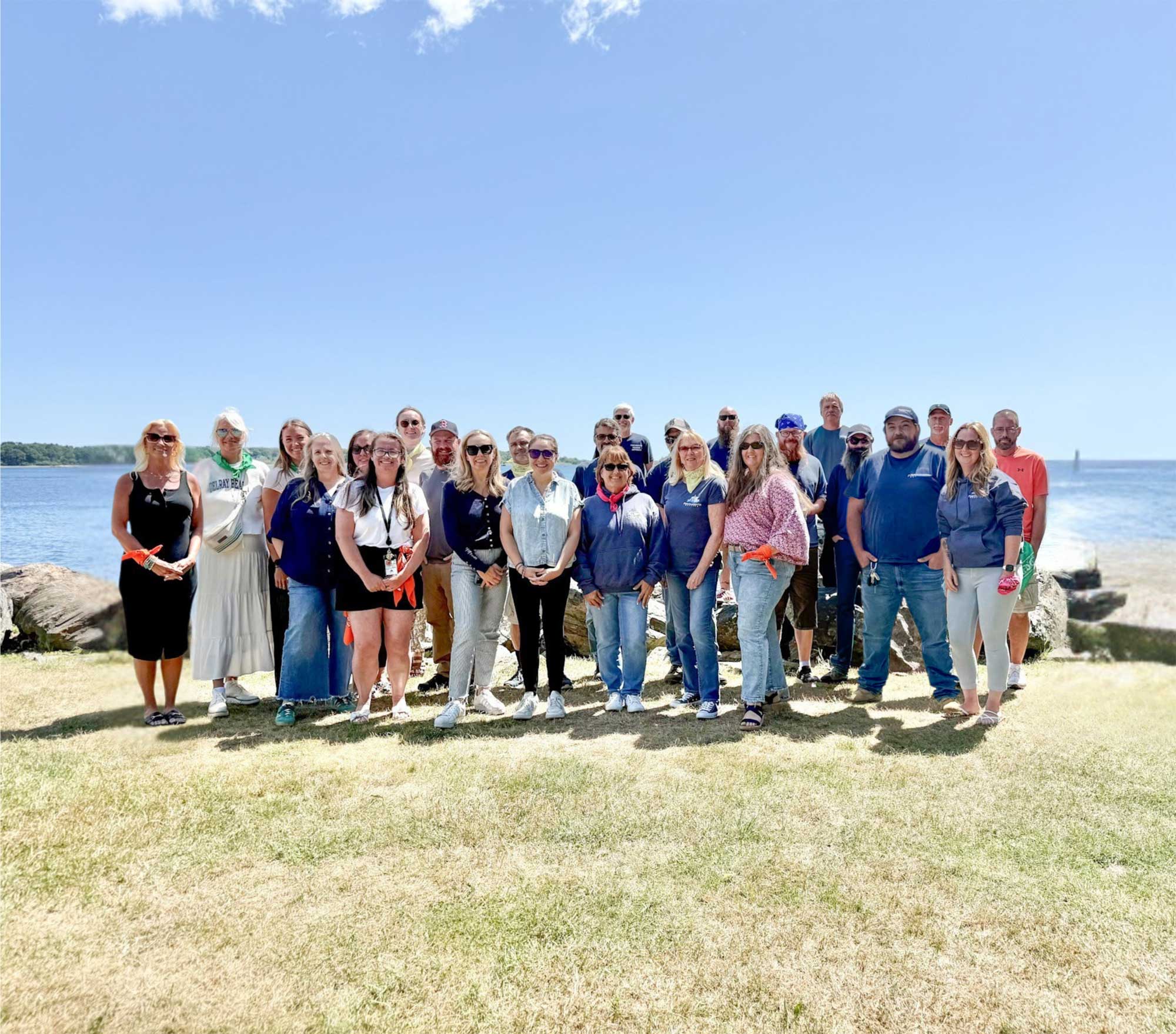 Group picture of the staff in front of the water