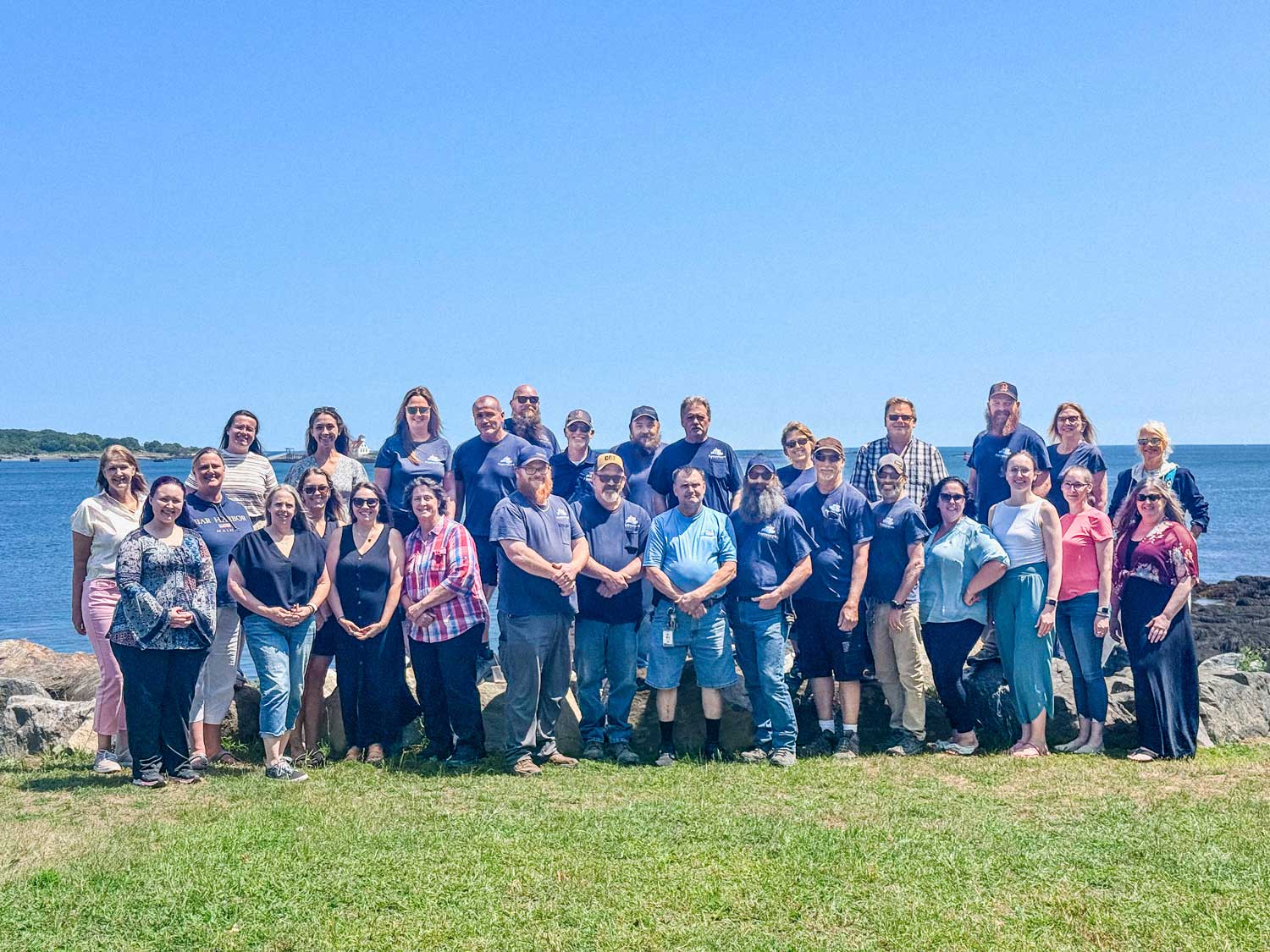 Group picture of the staff in front of the water