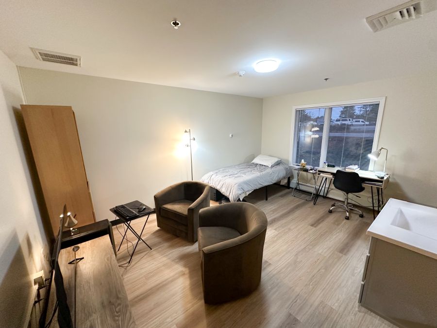 Bedroom with bed, desk, and seating area