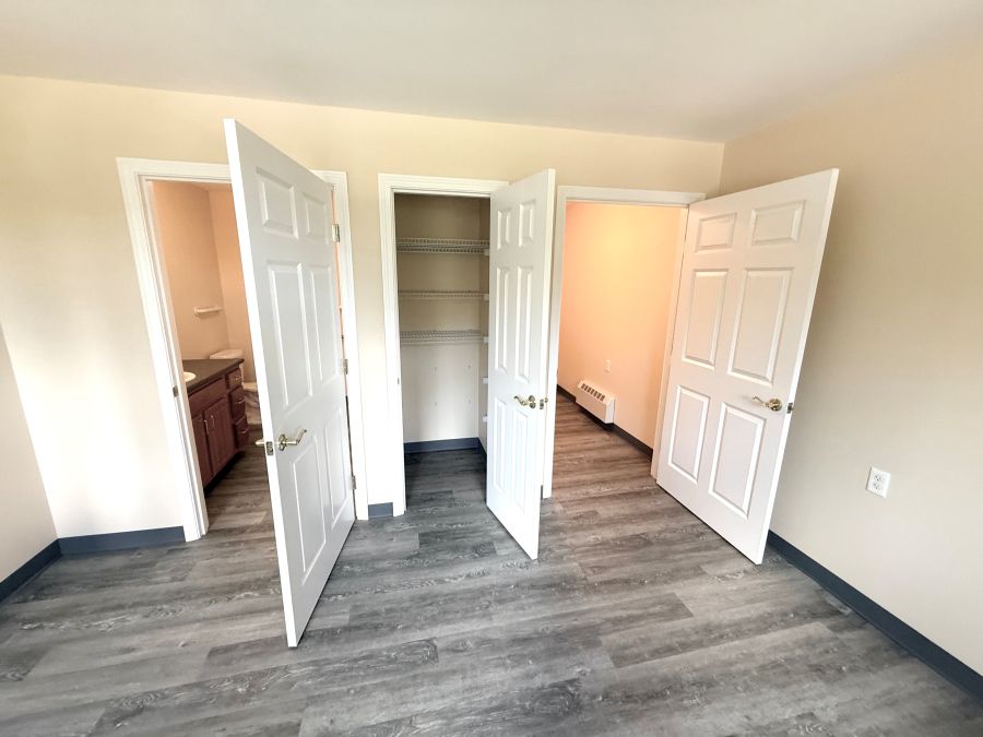 View of the bathroom, closet, and entry doors in the bedroom