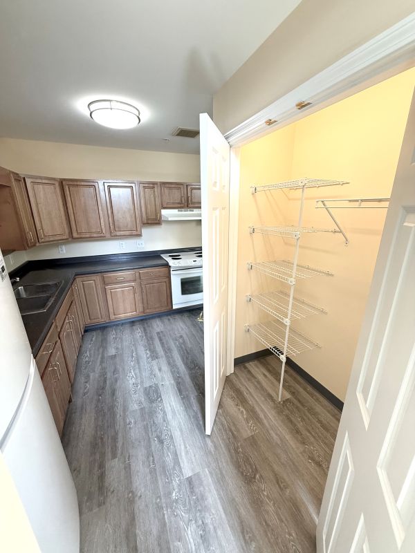 View of the kitchen from the side with the pantry door open