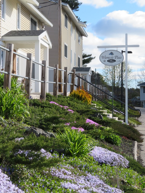 Flower beds in front of property and sign